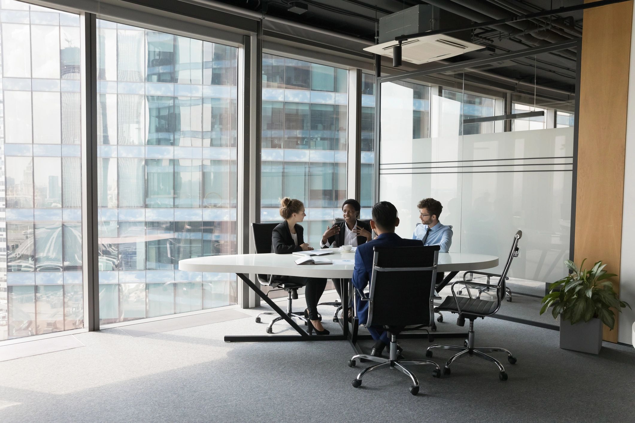 Professional team discussing technology solutions in a modern meeting room